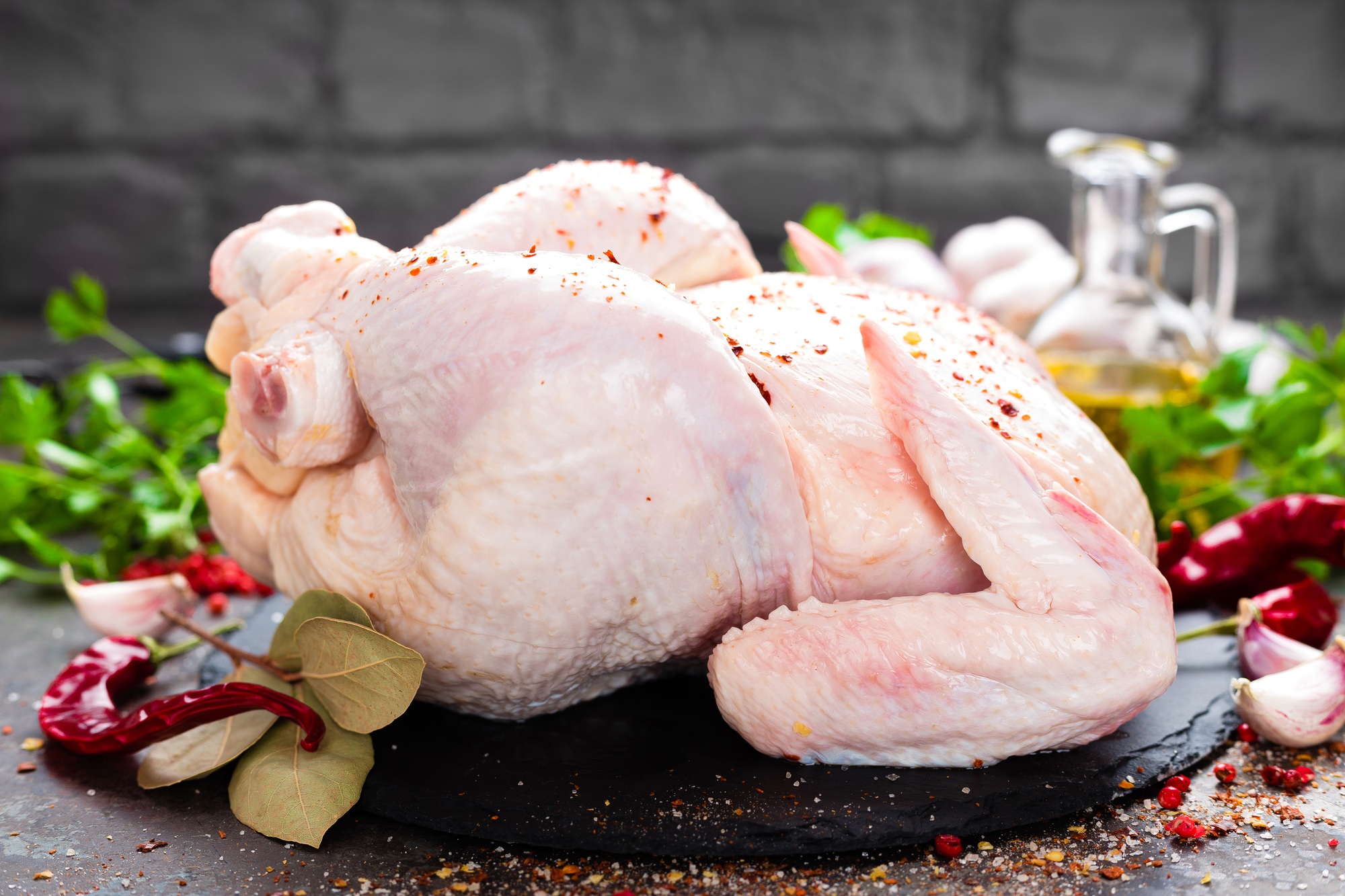 Raw chicken. Fresh whole chicken with ingredients for cooking