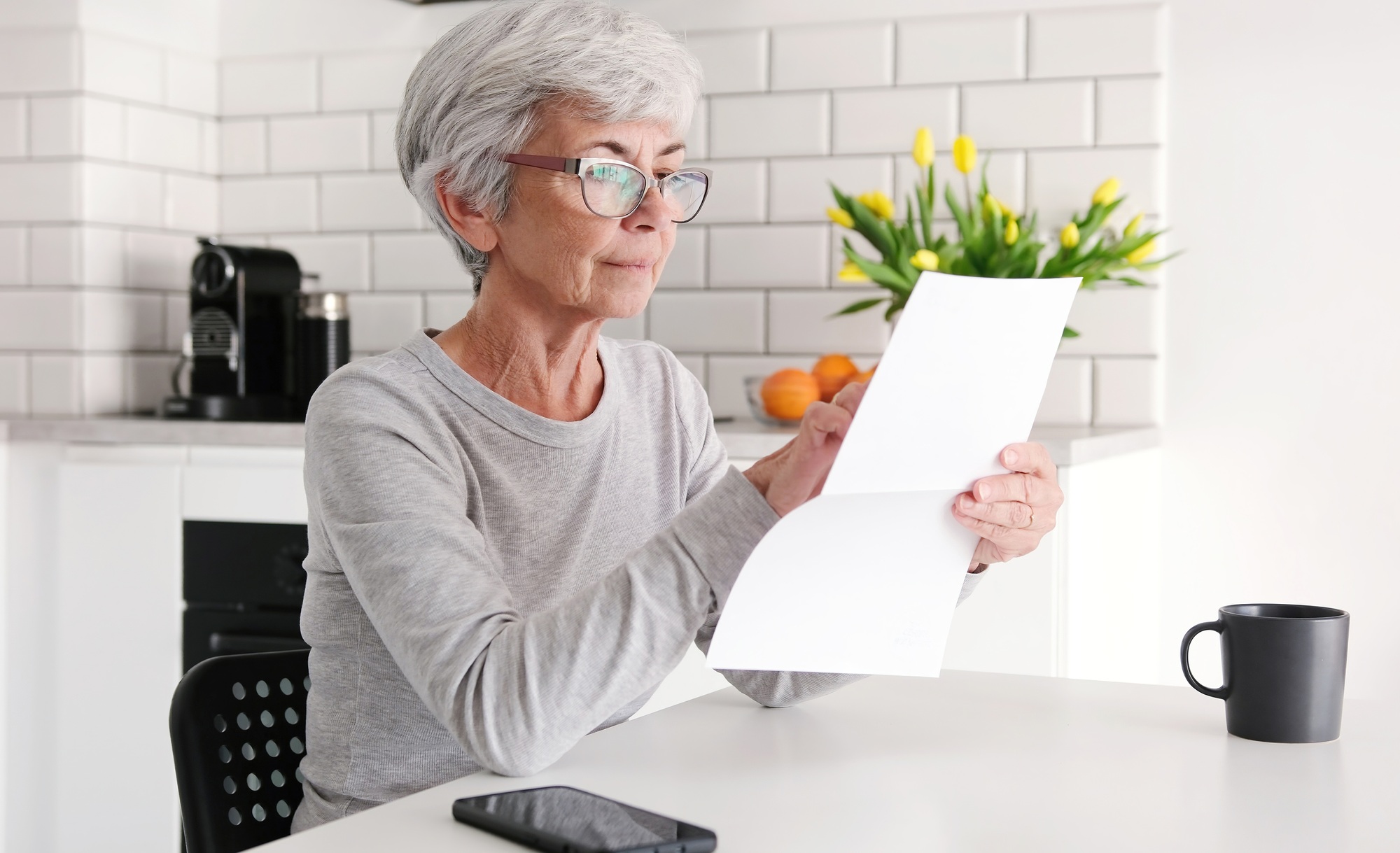 Middle Aged Woman Reading Financial Letter Document Attentively
