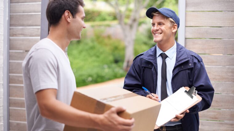 My parcel finally came. Shot of a young man receiving a parcel from the delivery man.