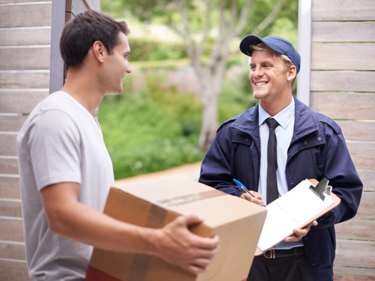 My parcel finally came. Shot of a young man receiving a parcel from the delivery man.